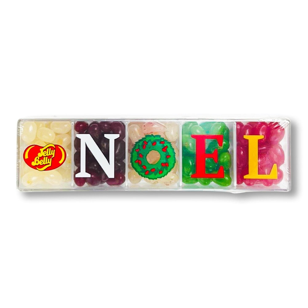 Une boite transparente avec 5 compartiments remplis de Jelly Belly jaune, blanc, rouge, verte et rose et une inscription « NOEL ». Le tout sur un fond blanc