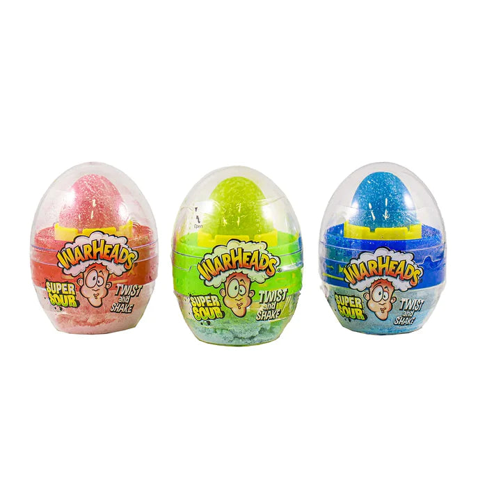 3 emballages en forme d’oeufs transparents avec à l’intérieur un bonbon rouge, vert et bleu à sucer, il y a un visage qui a la tête qui explose. Le tout sur fond blanc