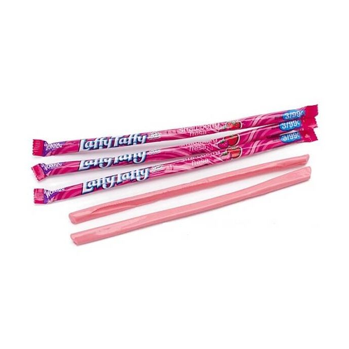 3 emballages fuchsia sur fond blanc avec des fraises et juste devant 2 bonbons en forme de bâtonnets roses déballés